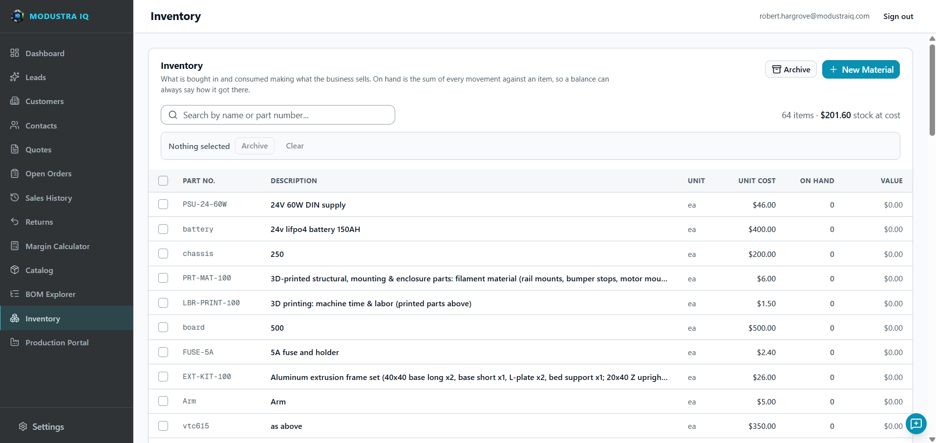The Modustra IQ Inventory list: a search box, a count of 64 items with the total stock at cost, Archive and New Material buttons, and a table of materials with part number, description, unit, unit cost, quantity on hand and value.
