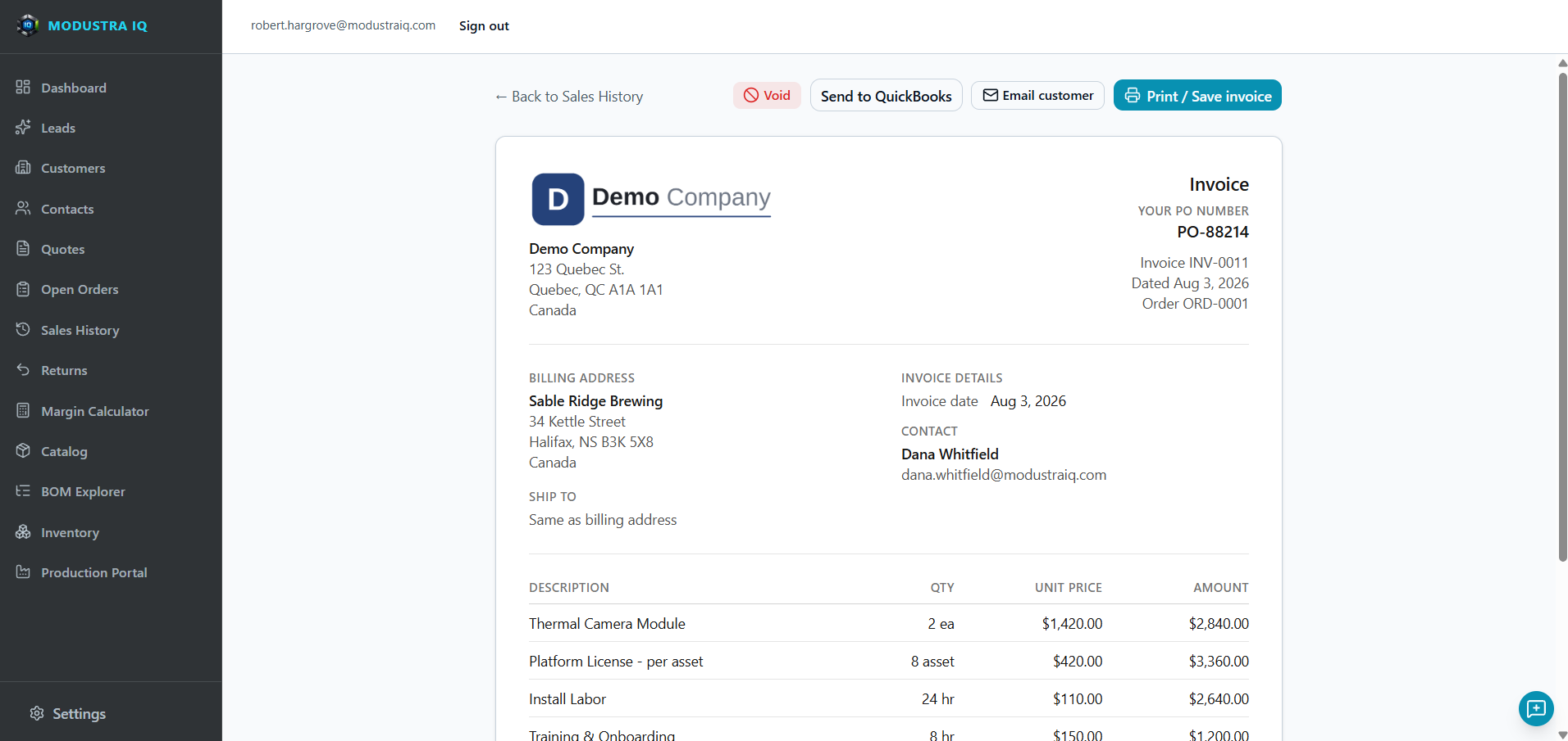An invoice open in Modustra IQ's Sales History with Void, Send to QuickBooks, Email customer and Print / Save invoice buttons above it. The invoice shows the Demo Company header and address, the customer's PO number, invoice number, date and order number, the billing and ship-to addresses, the contact, and line items for a thermal camera module, platform licences per asset, install labour and training in hours, each with quantity, unit price and amount.